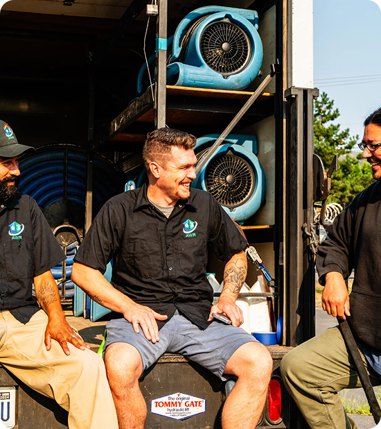 AWR Restoration & Cleaning technicians next to a truck loaded with drying equipment